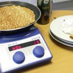 Asynt making pancakes on a hotplate